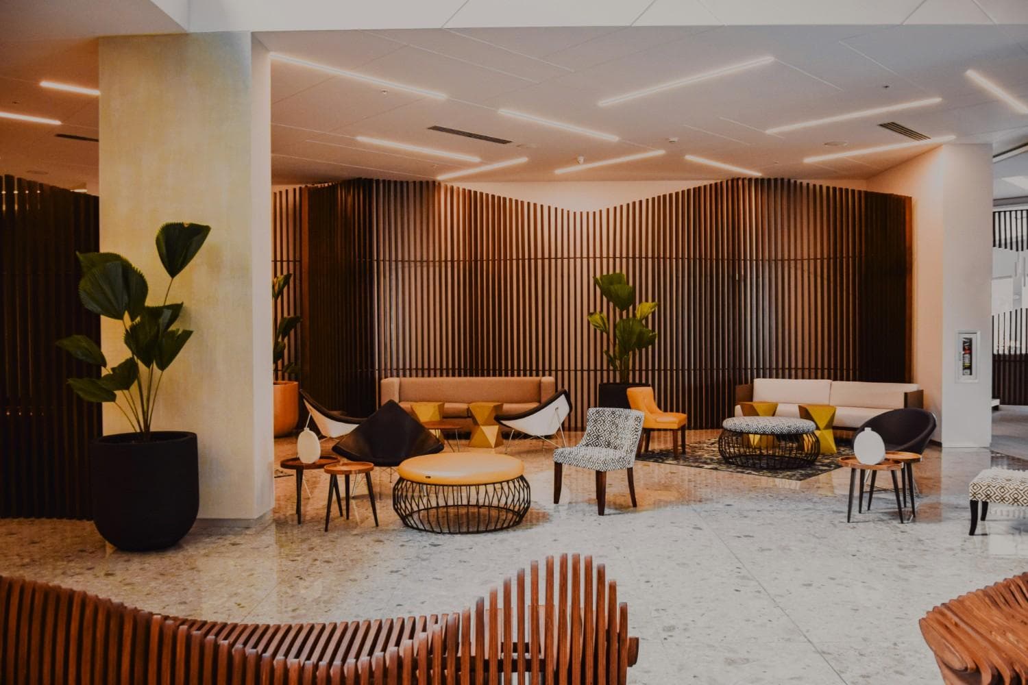 Modern hotel lobby with designer seating and warm lighting